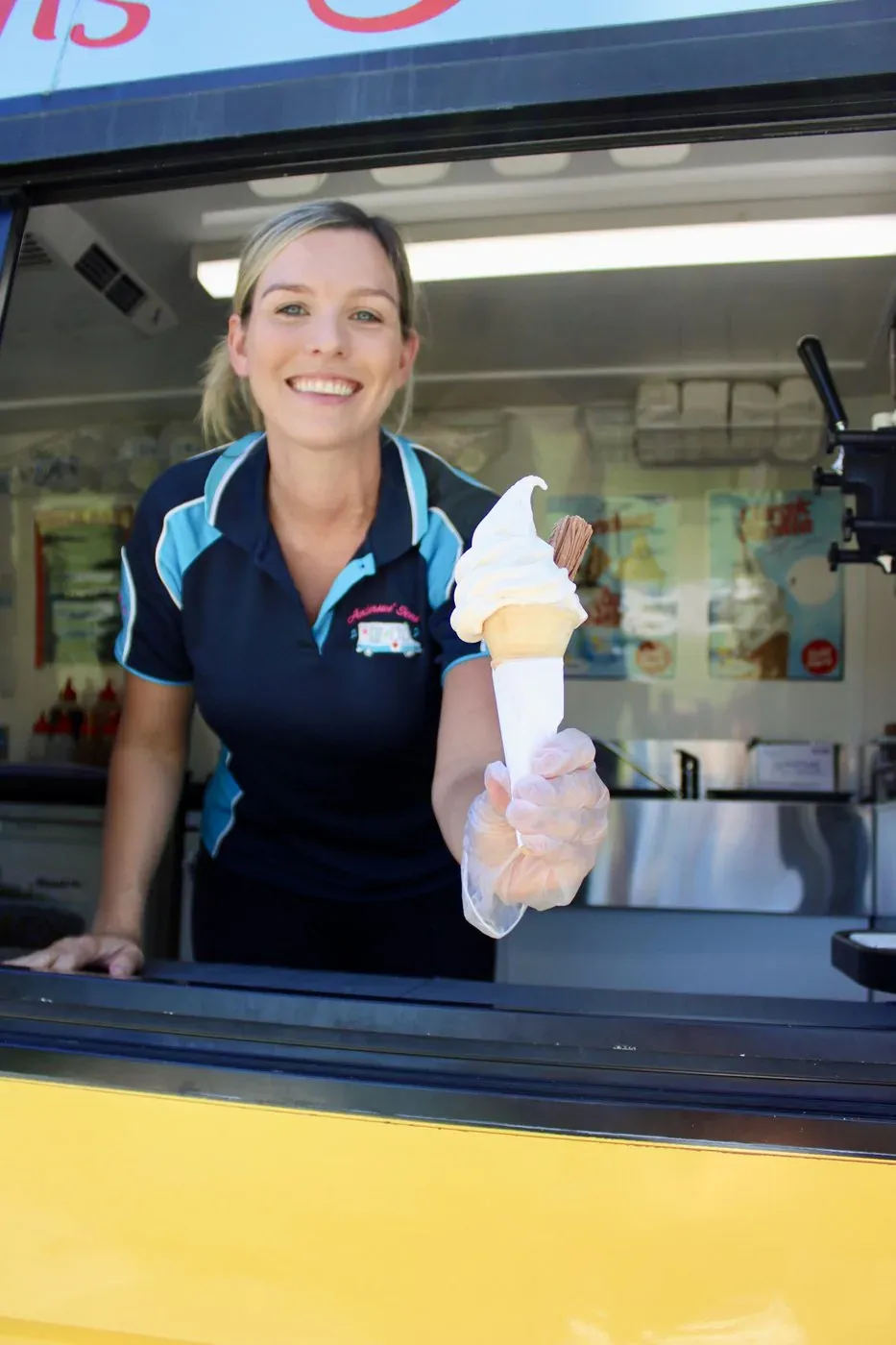 Serving a traditional whippy soft serve from the Andersons' Ices van window at a Gold Coast event