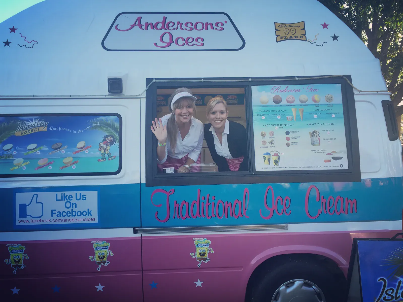 Sammy and Janet Anderson waving from the serving window of the family ice cream van, Andersons' Ices