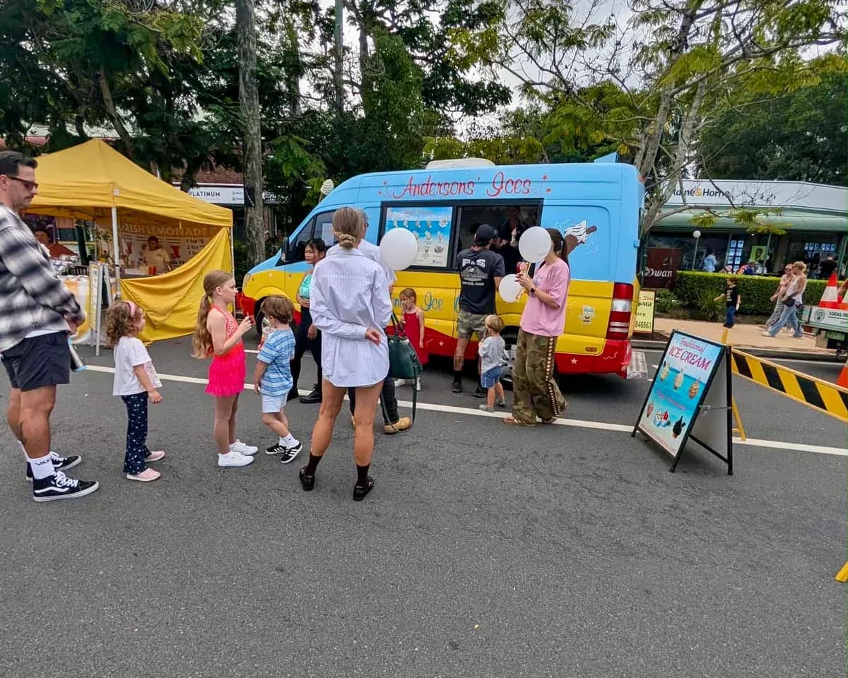 Families queuing at the Andersons' Ices van at the Mudgeeraba Street Party community event on the Gold Coast