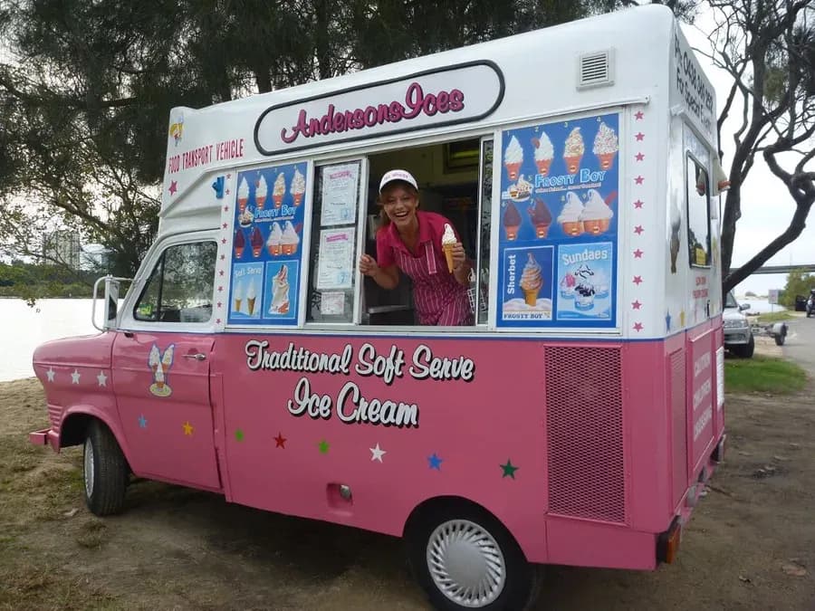 Janet Anderson serving a traditional soft serve cone from the window of the pink Andersons' Ices van, 2011